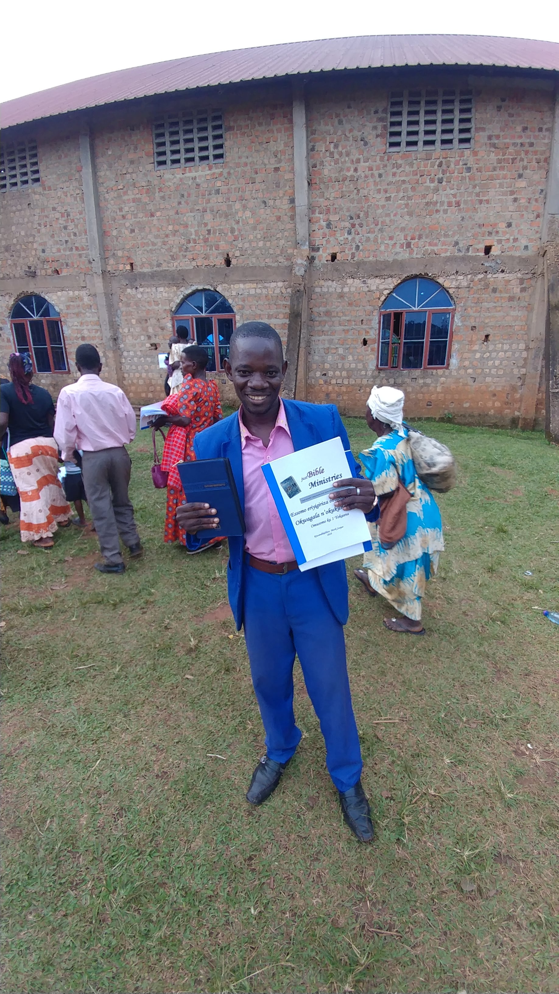 A pastor receives a workbook and Bible, 2019.