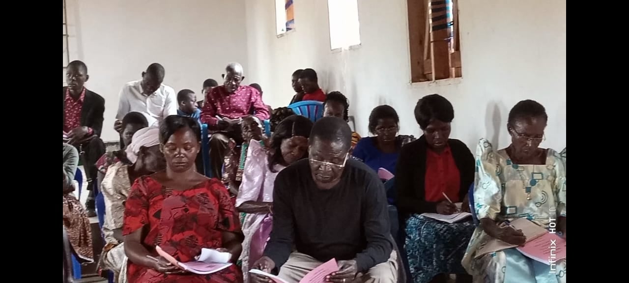 A congregation with study handouts, 2023.