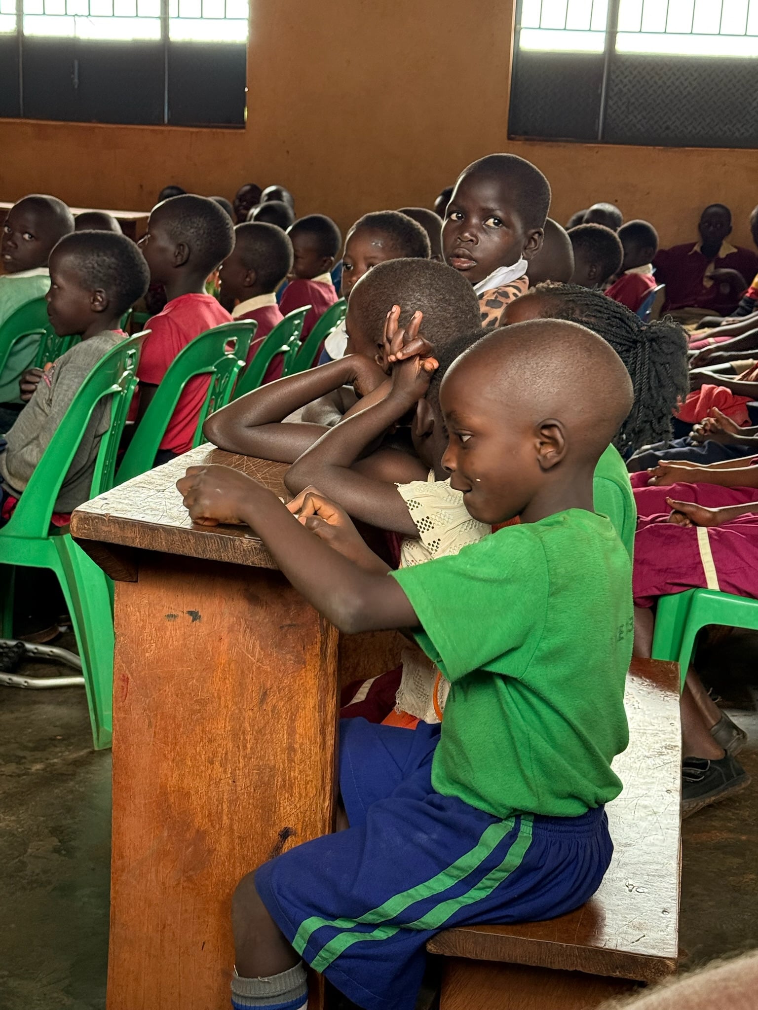 A boy at his desk in the hall, 2025.