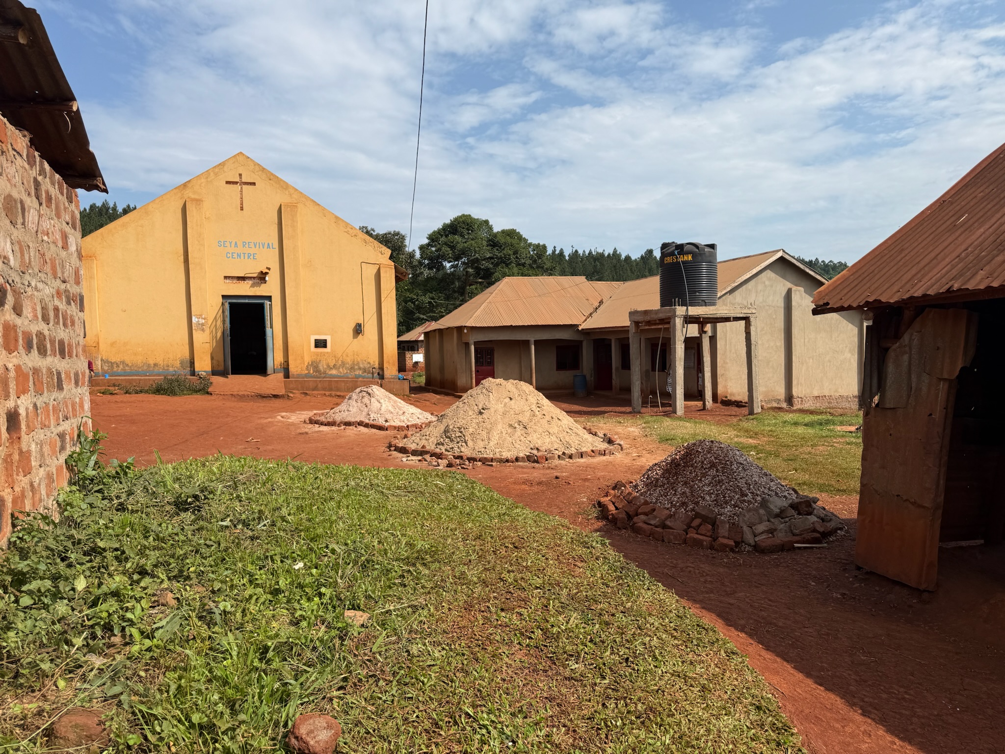 Sand and material piles at Seya compound — prep for new classrooms.