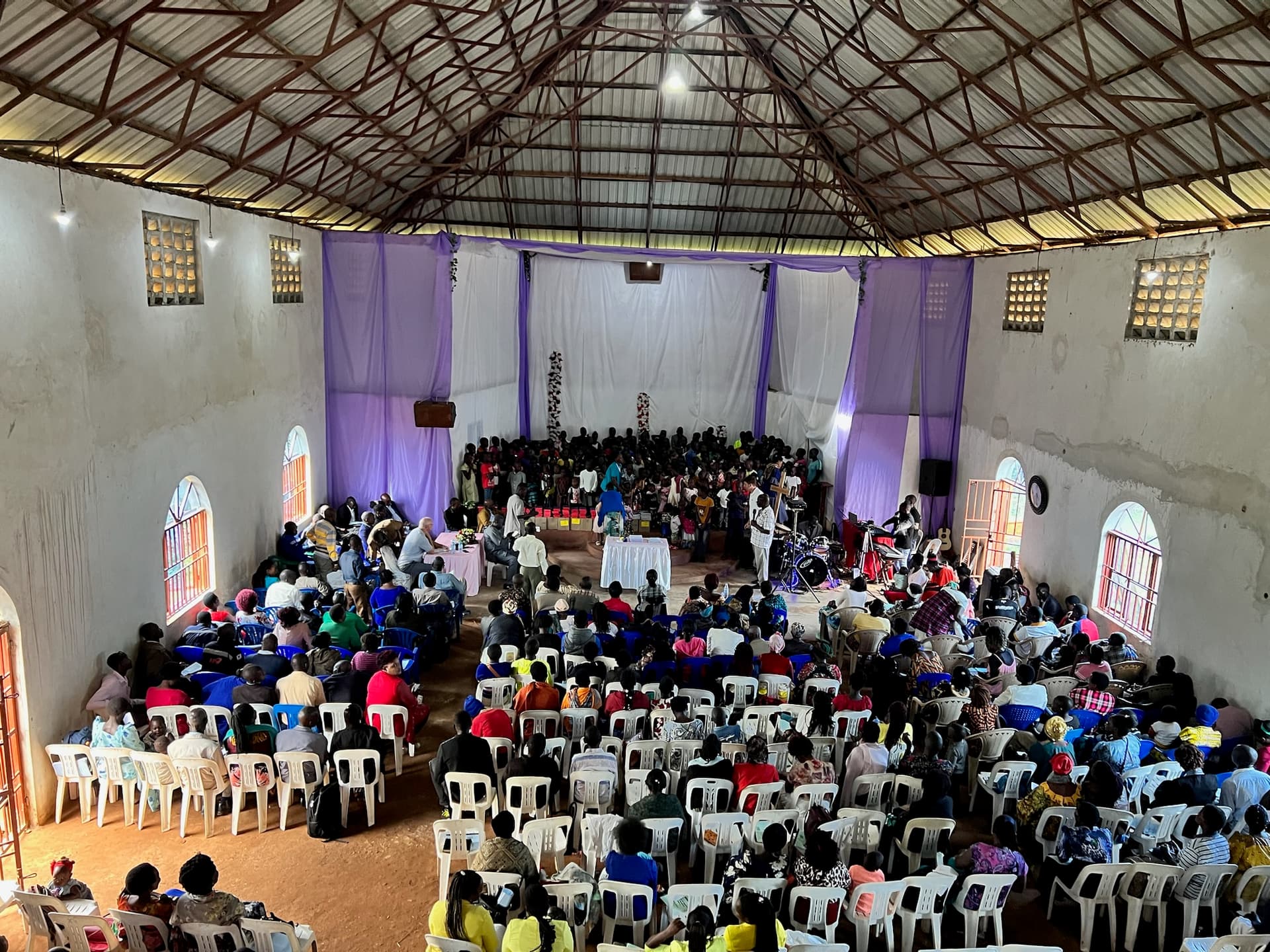 A packed hall seen from the balcony at the 8th Symposium.